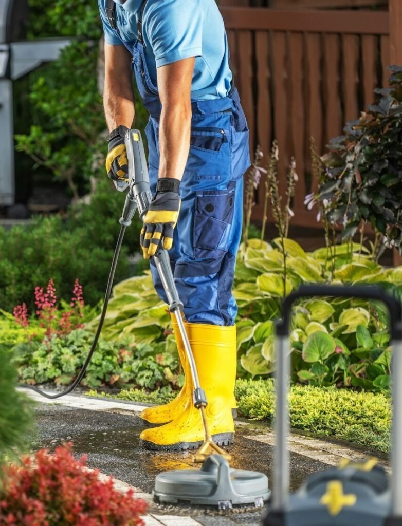 Homeowner Pressure Washing His Bricks Garden Path